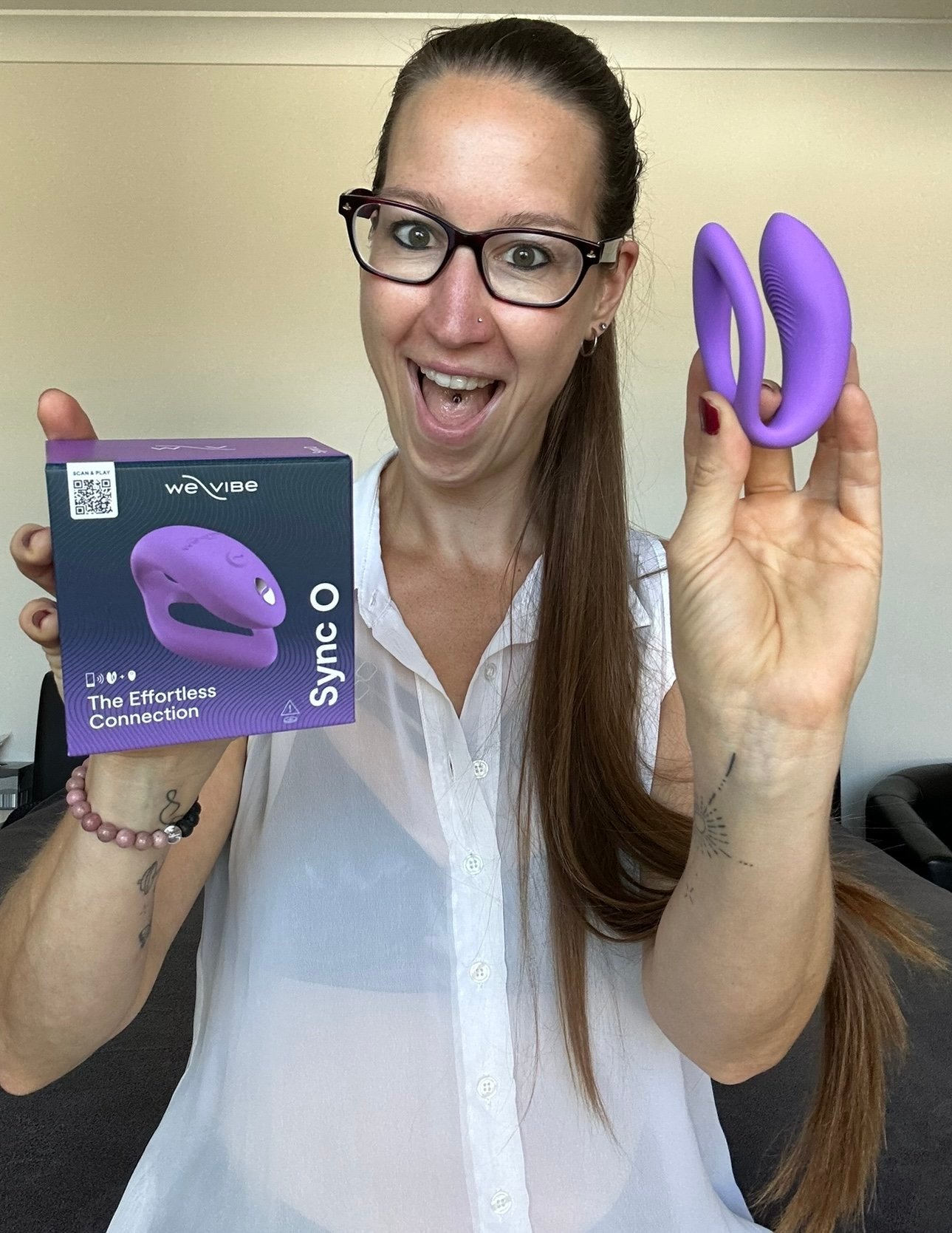 Pleasure Toy Queen Patricia holding the we-vibe sync O