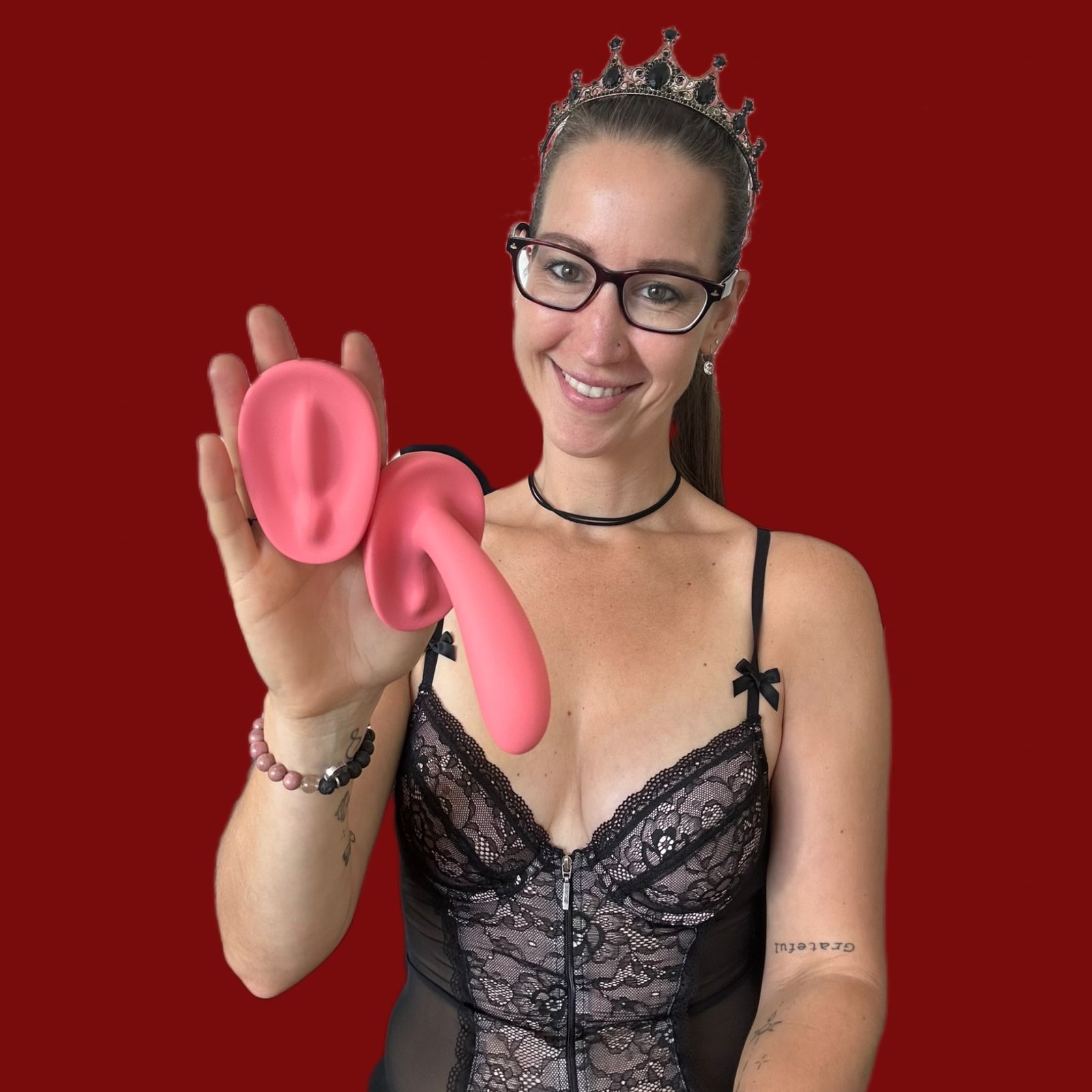 Pleasure Toy Queen Patricia holding two vibrators