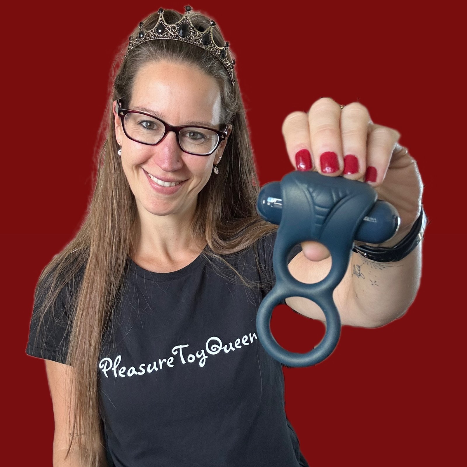 Pleasure Toy Queen Patricia holding the lux active double cock ring