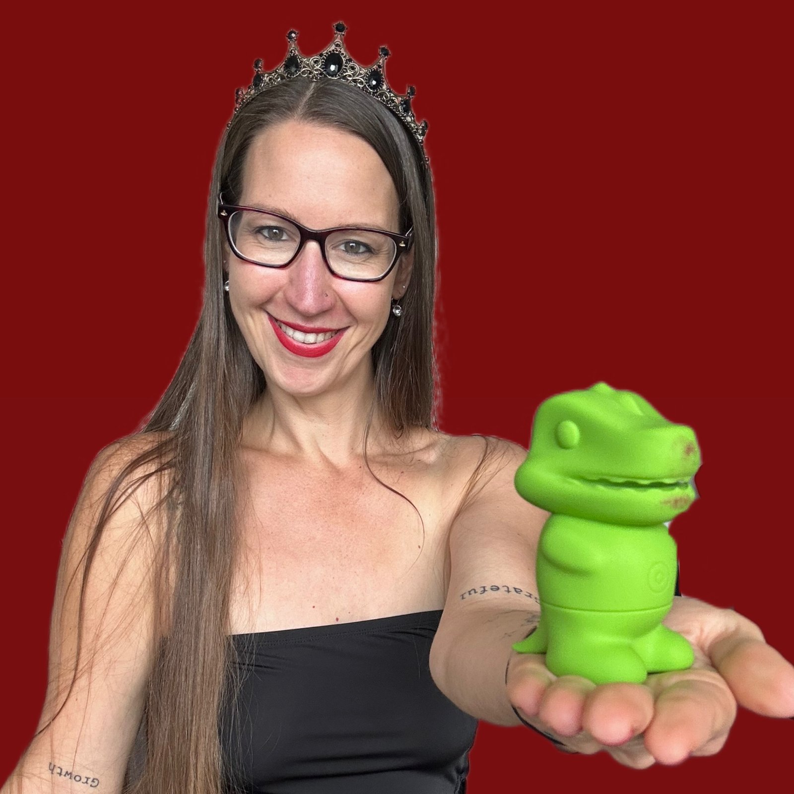 Pleasure Toy Queen Patricia holding the little suck o saurus Goo vibrator