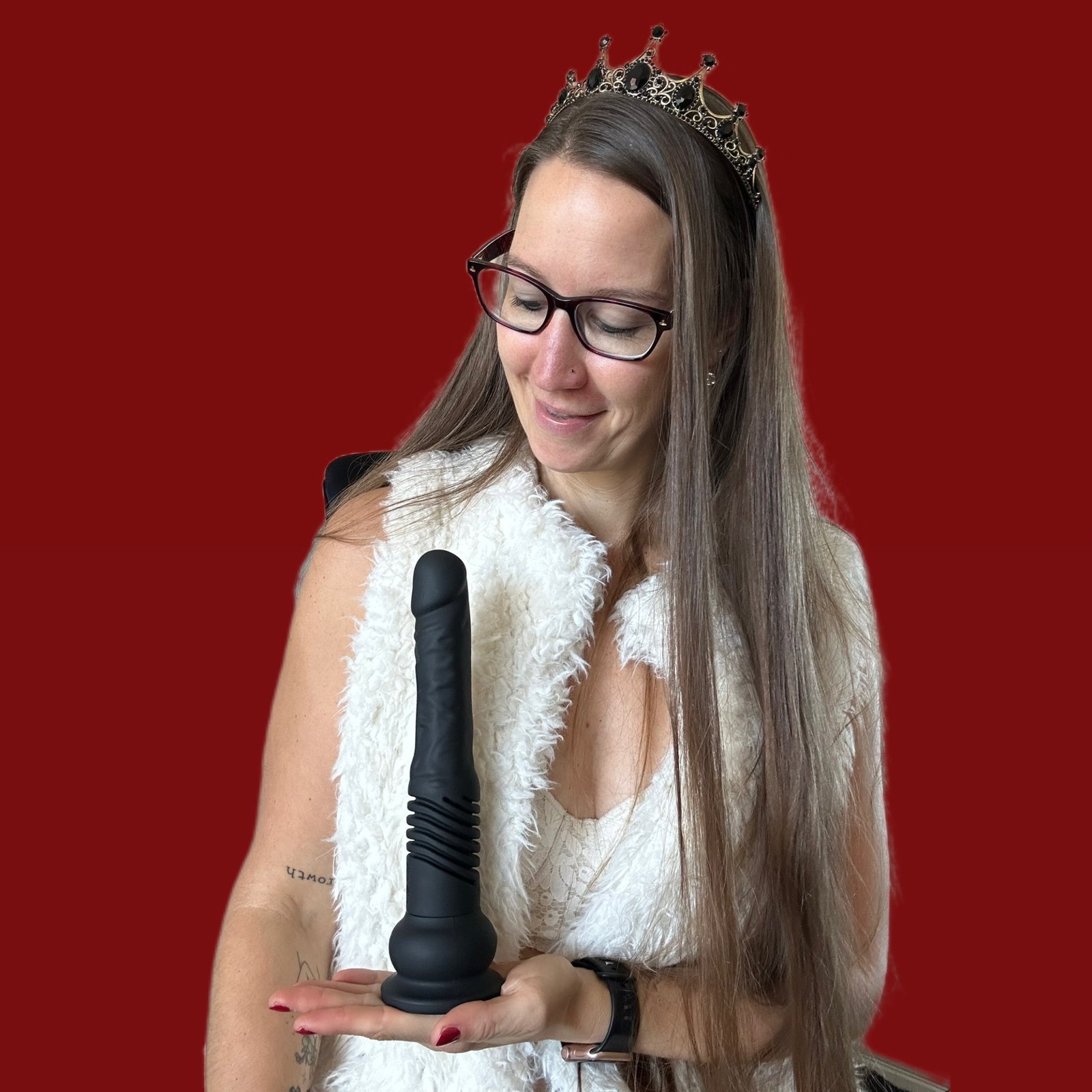 Pleasure Toy Queen Patricia holding the velvet thruster dildo