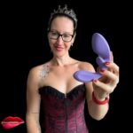 Pleasure Toy Queen Patricia holding the Flow rabbit vibrator from OSUGA