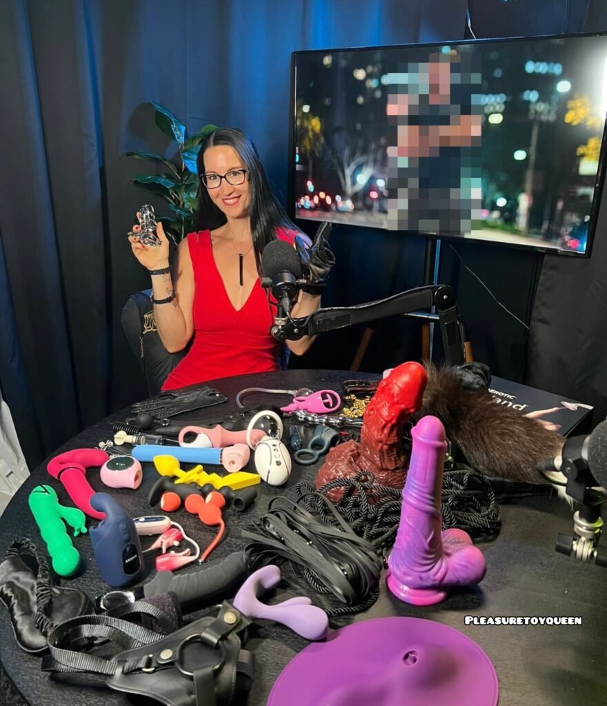 Pleasure Toy Queen Patricia with a selection of pleasure toys and kinky tools at a podcast studio